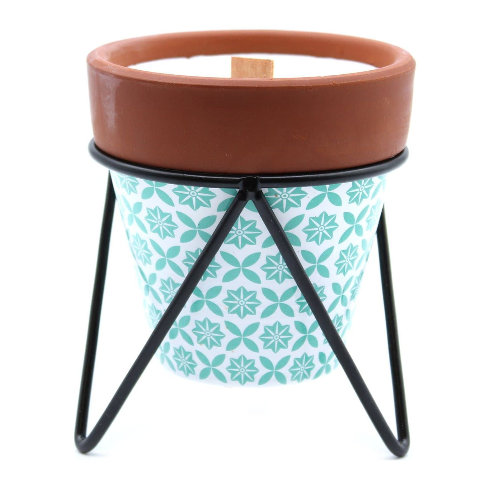 Terracotta pot candle on a black metal stand