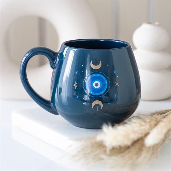 Dark blue mug with an all-seeing eye, moons and stars