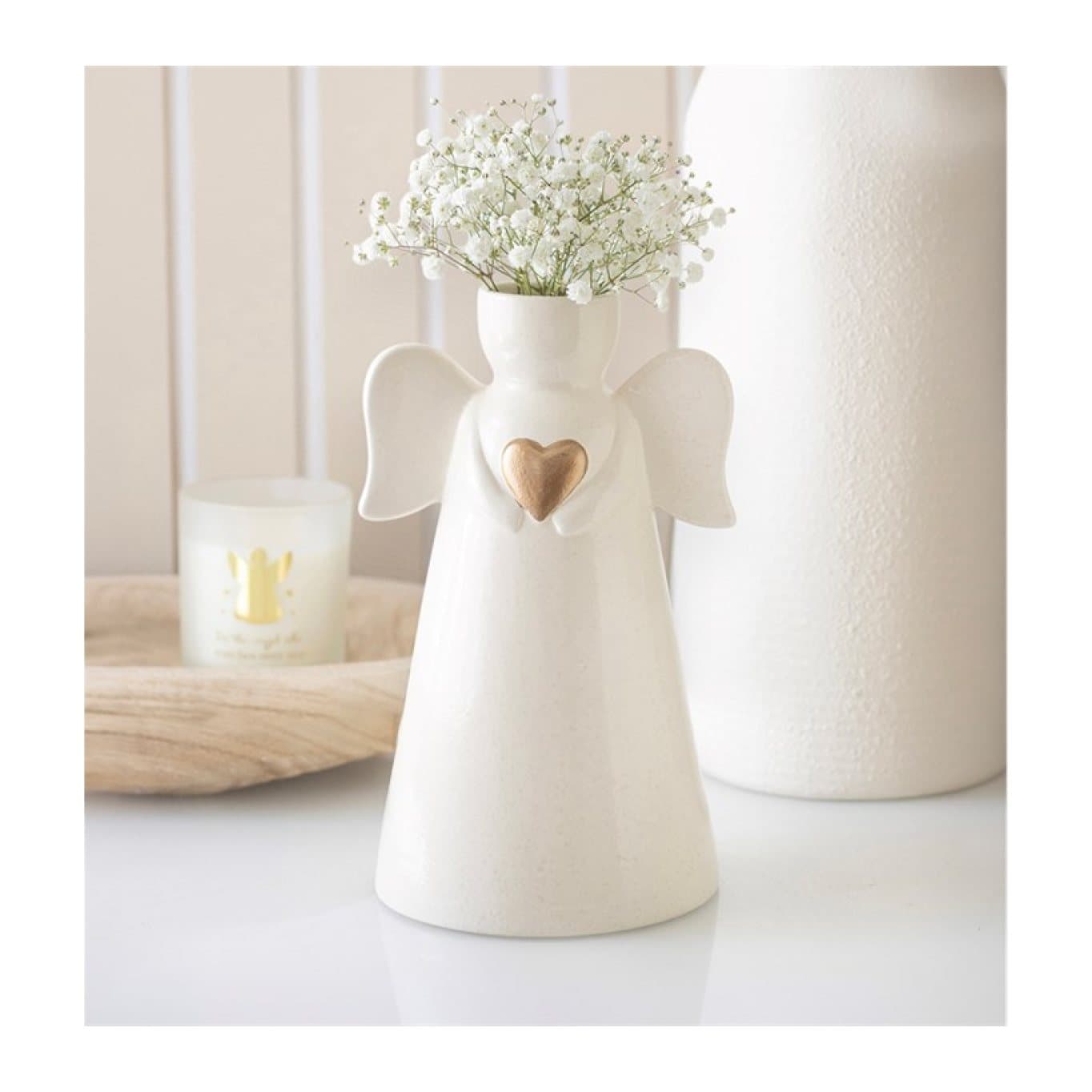 Off-white ceramic angel shaped vase with sculpted wings and a gold heart