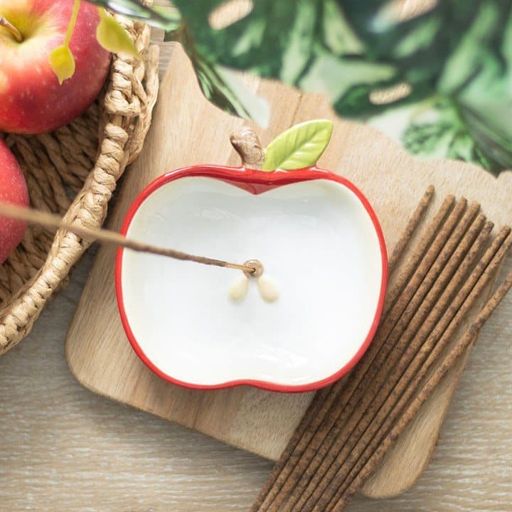 Red ceramic incense holder shaped like an apple