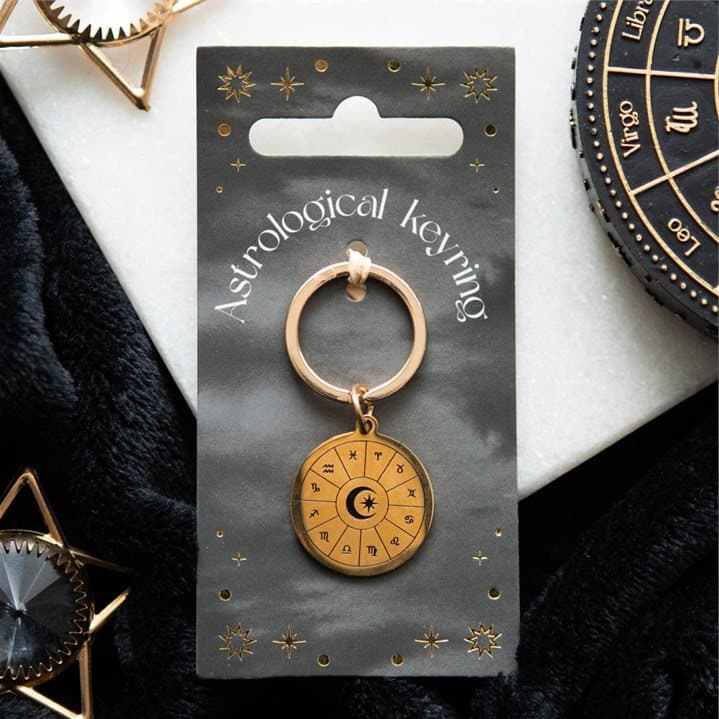 Gold tone astrology wheel keyring on a matching backing card