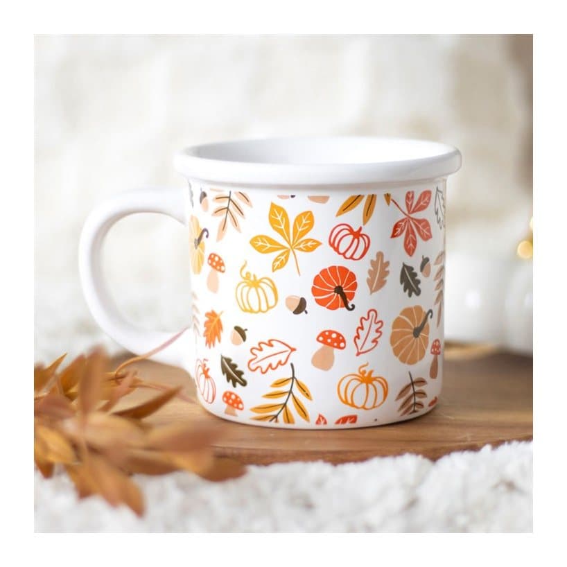 Chunky mug printed with autumn leaves and pumpkins in orange and red