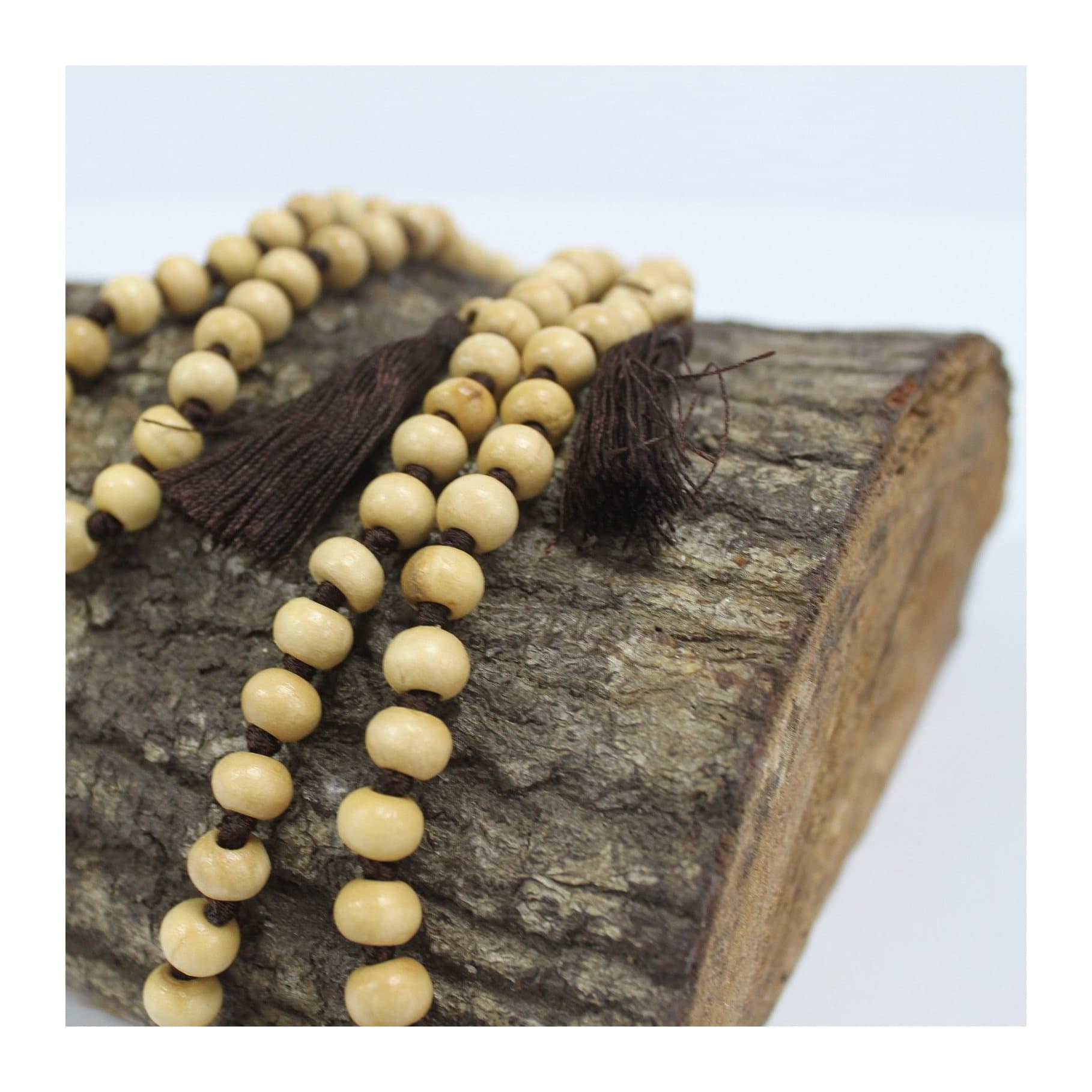 Brown wooden bead necklace with a chunky tassel and two small tassels