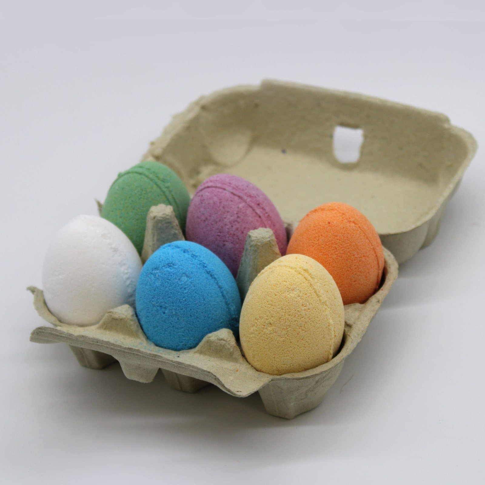 Six egg-shaped bath bombs in a tray