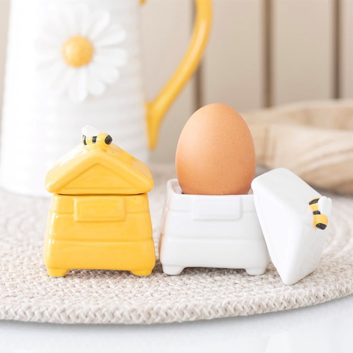 Two ceramic egg cups shaped like beehives