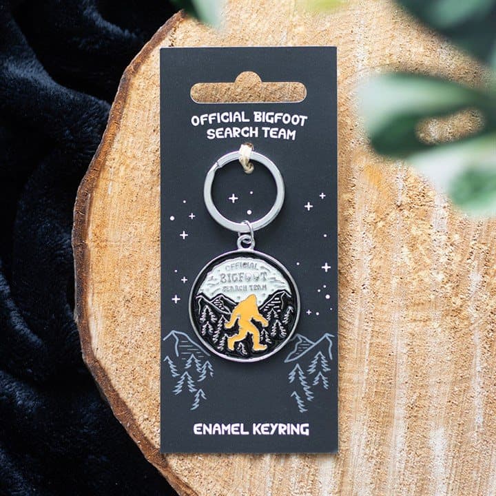 Enamel Bigfoot Search Team keyring on a cardboard backing card