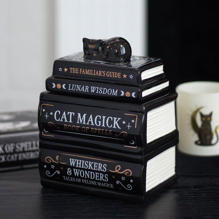 Ceramic stack of books with a black cat on top