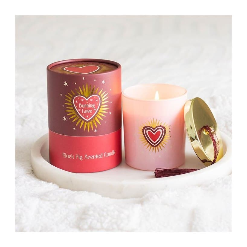Blush pink glass candle jar with gold lid and tassel, with a sacred heart design