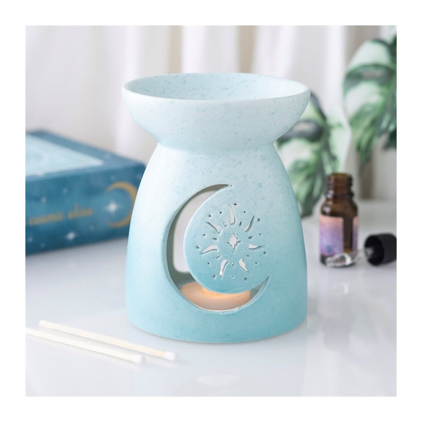 Pastel blue ceramic oil burner with a moon cut-out