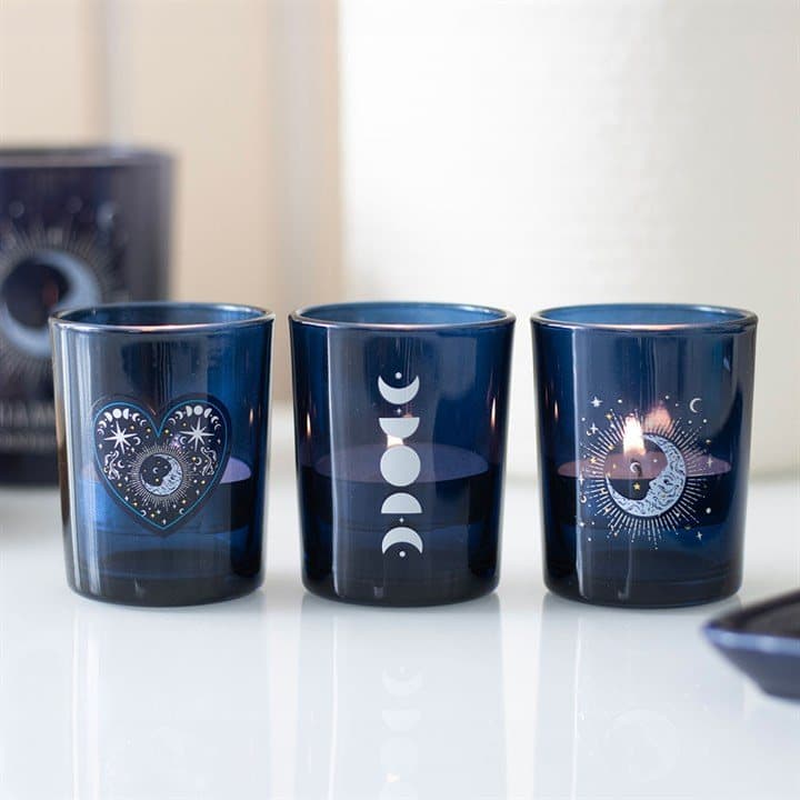 Three blue glass moon votive holders