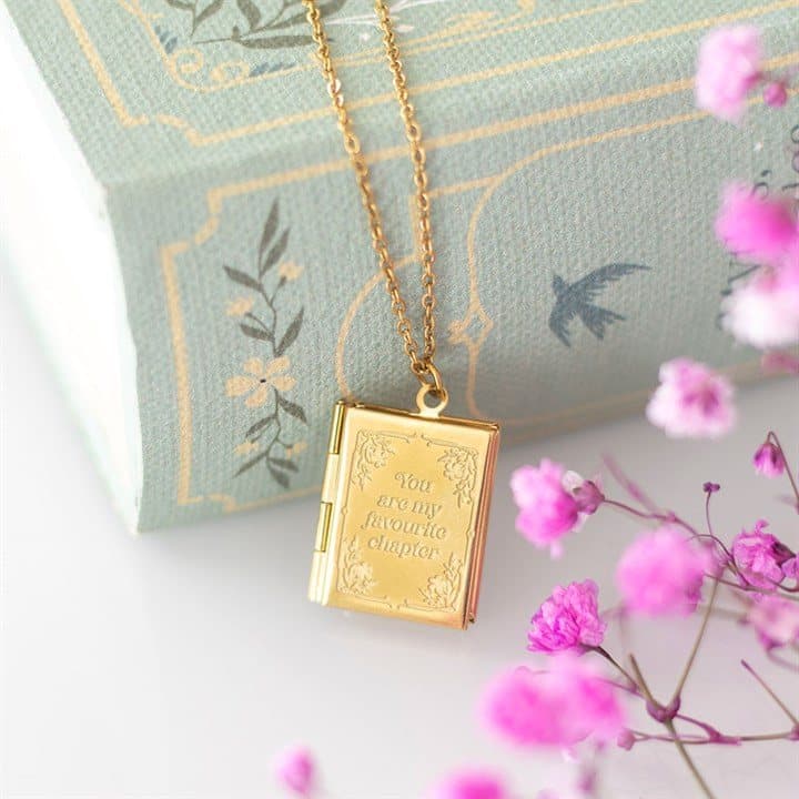 Gold-toned locket necklace shaped like a small book