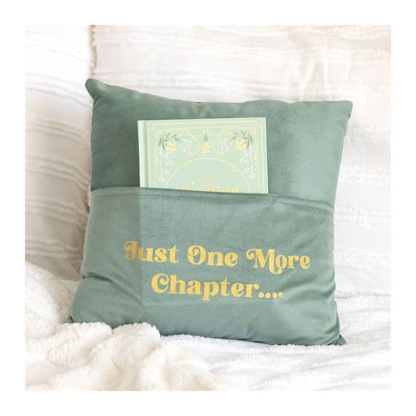 Pale green square cushion with 'Just One More Chapter' text and a front pocket