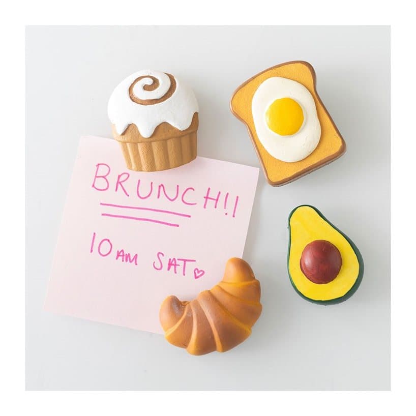 Four colourful resin brunch fridge magnets on a cardboard back