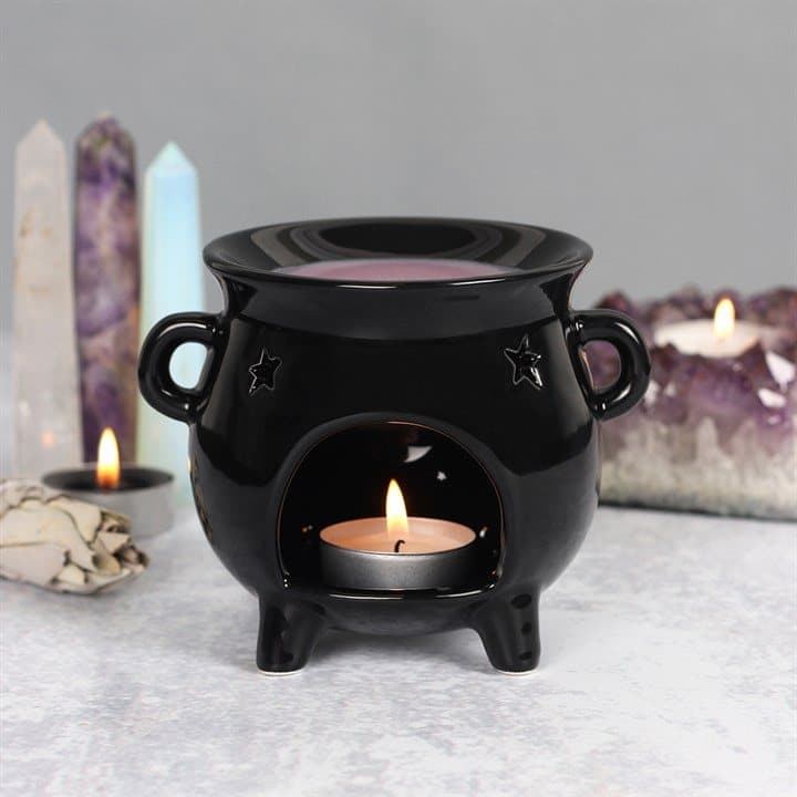 Black ceramic cauldron oil burner with a cut out star detail