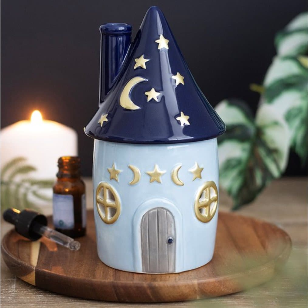 Ceramic cottage oil burner with a starry pointed roof