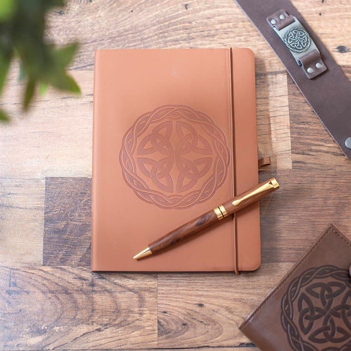 Brown Celtic knot notebook with a pen