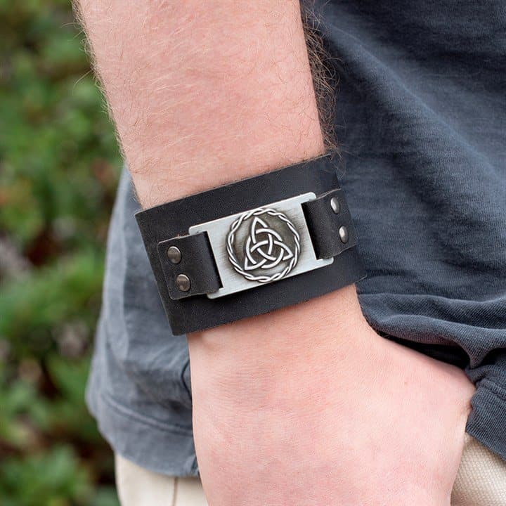 Brown leather cuff bracelet with a metal Celtic knot
