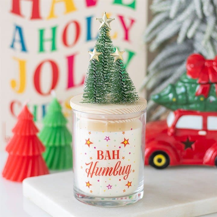 Christmas glass candle with a colourful design and a wooden lid topped with a small tree