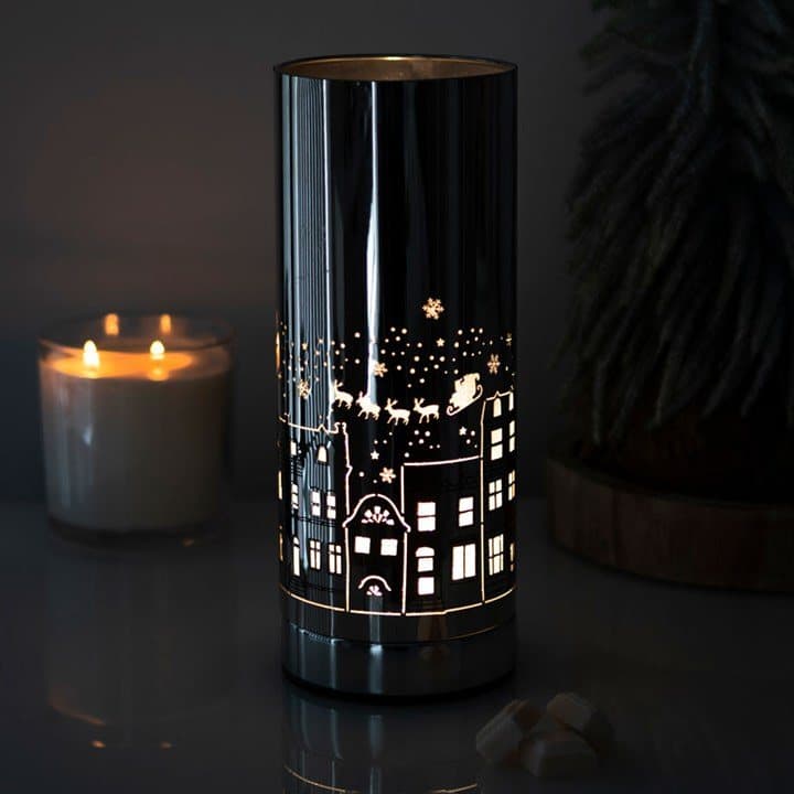 Metal electric aroma lamp with a lit Christmas village design