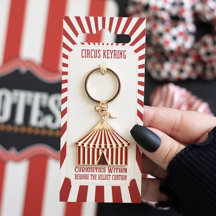 Striped circus tent enamel keyring with a tiny golden flag