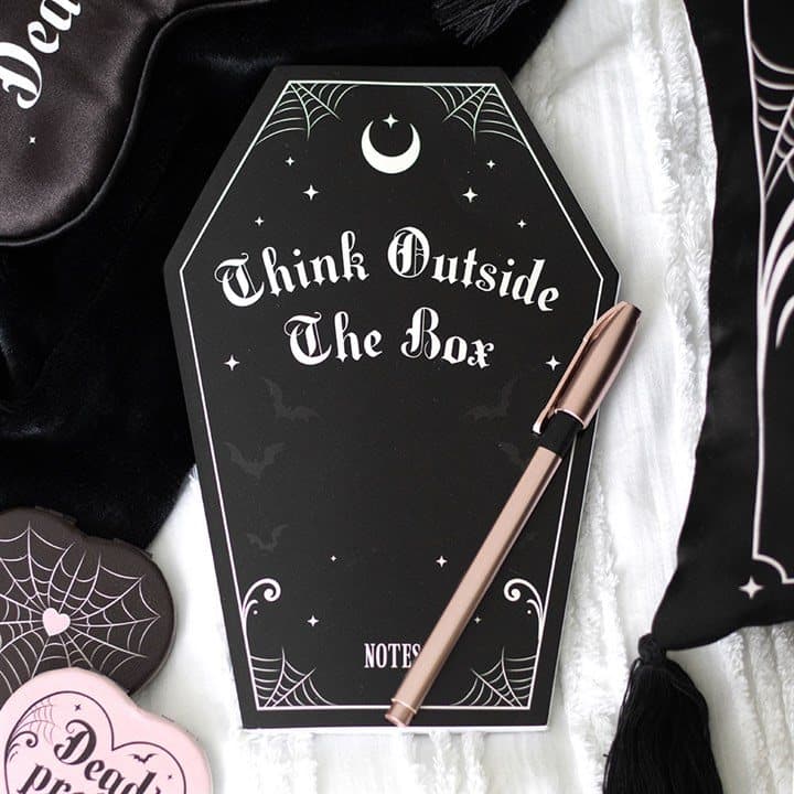 Black coffin shaped notebook with pink accents