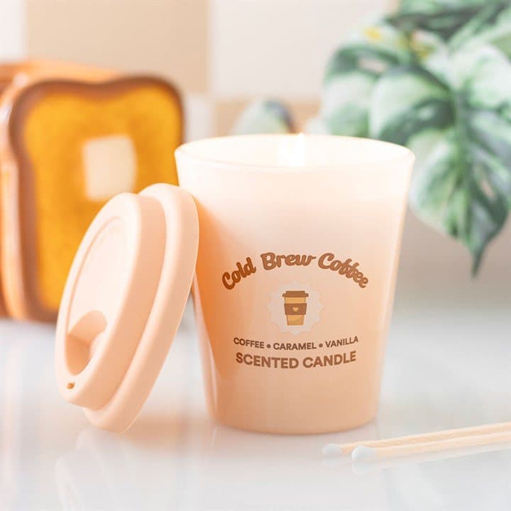 Cold brew coffee scented candle in a glass beside its gift box