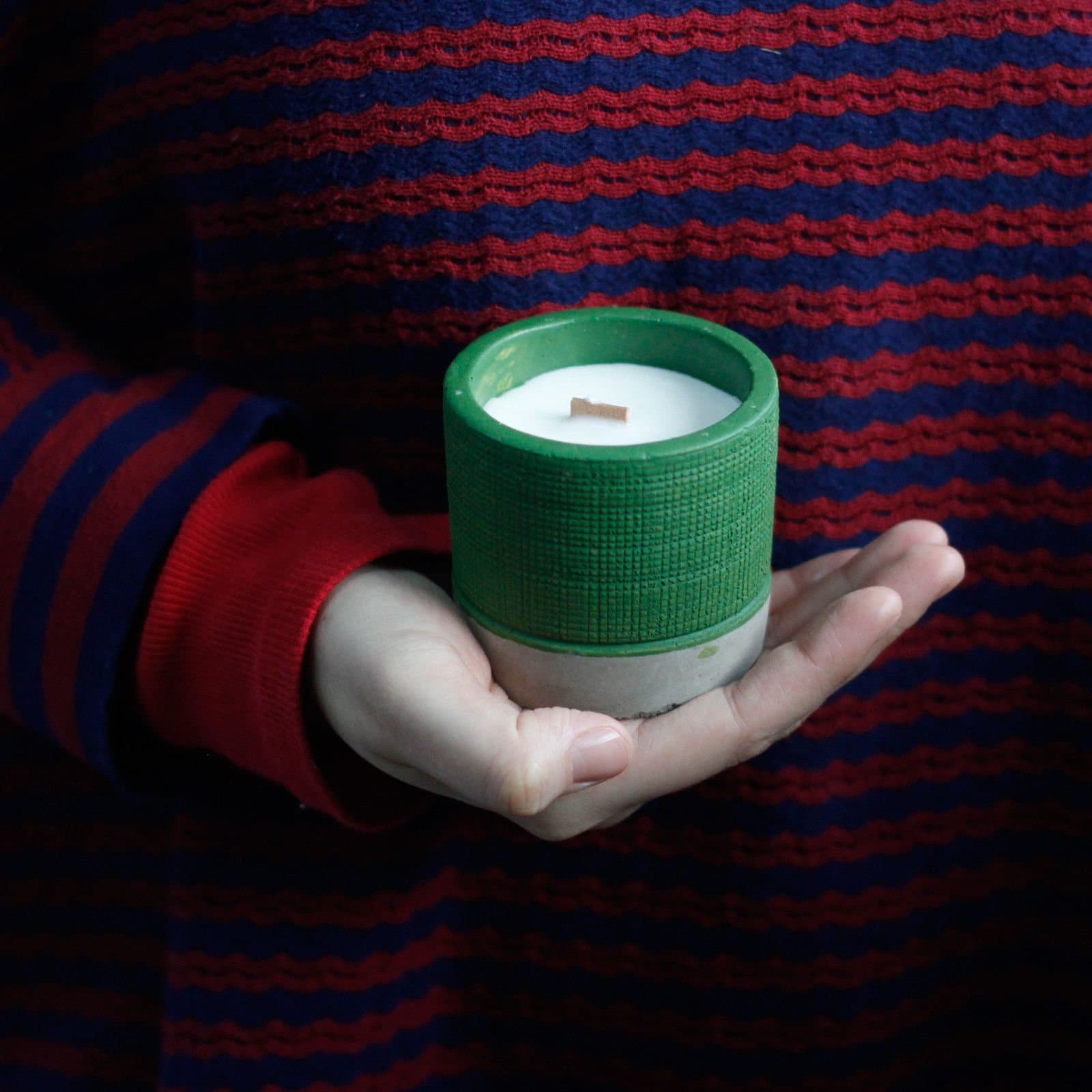 Soy candle with a wooden wick in a concrete pot