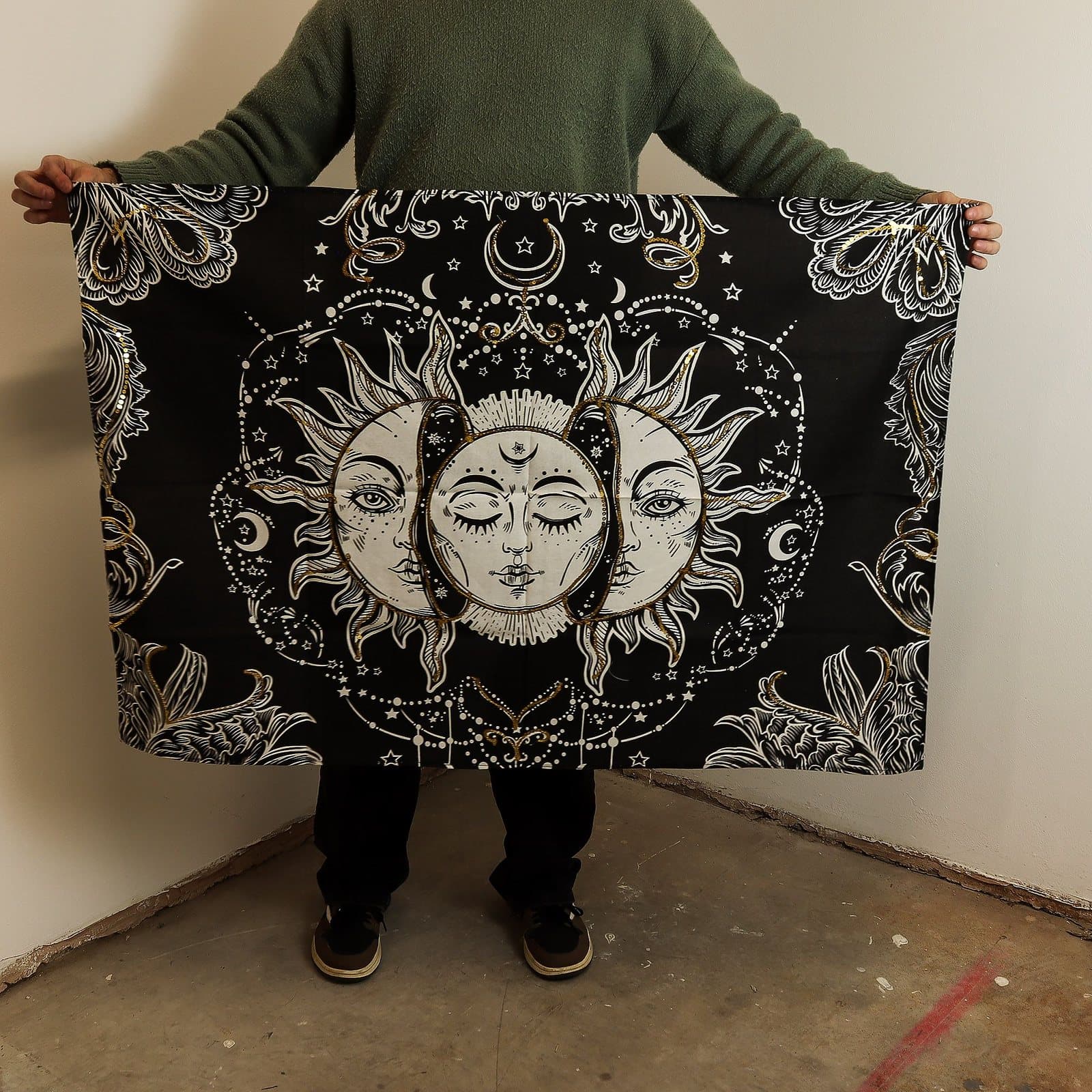 Cotton wall hanging of a gold and white Sun Goddess with moons and stars on black