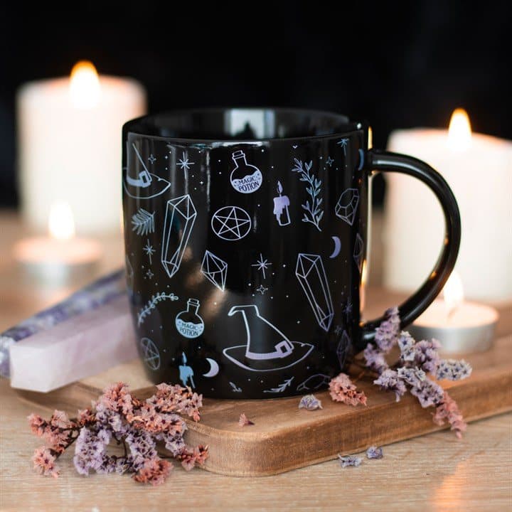 Ceramic mug with a black crystal and magic design