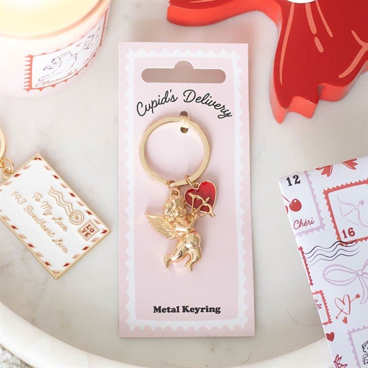 Enamel cupid cherub keyring on its cardboard back