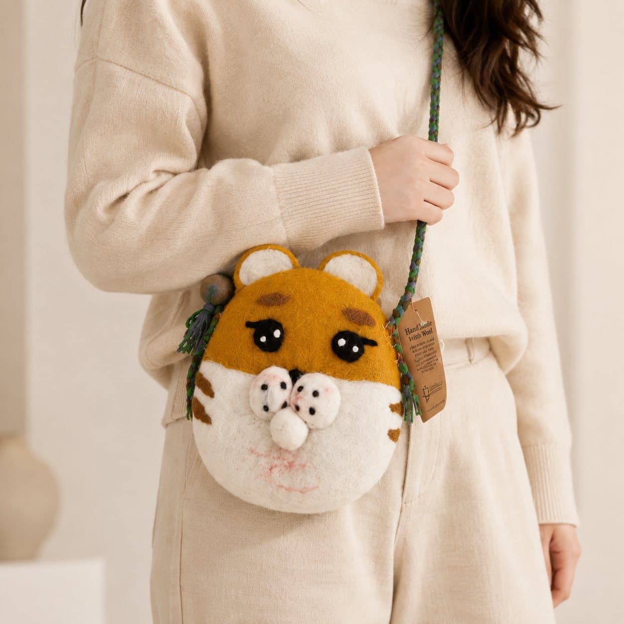Felted tiger bag with mustard-yellow face, mint-green back and braided strap