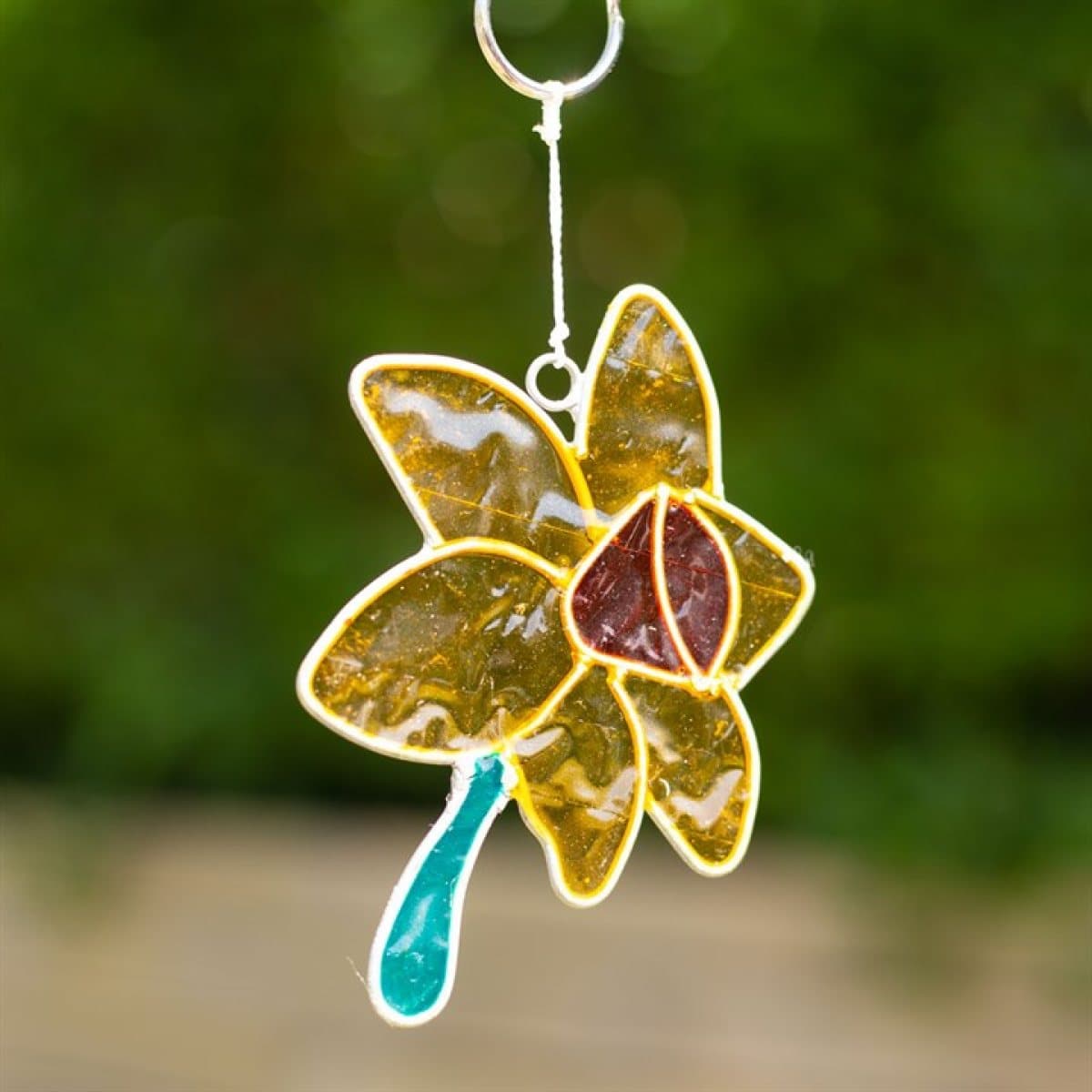 Daffodil suncatcher hanging in a window