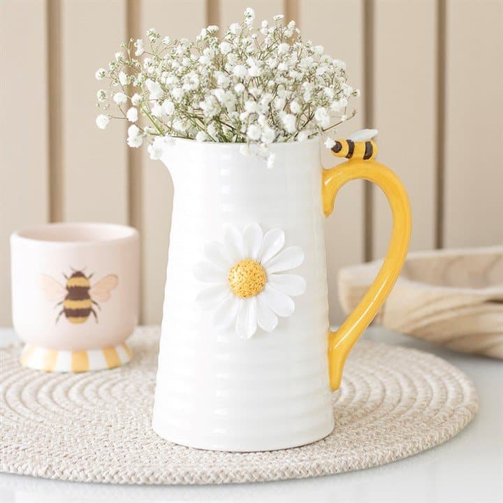 Ceramic flower jug with raised white daisies and honey bee details