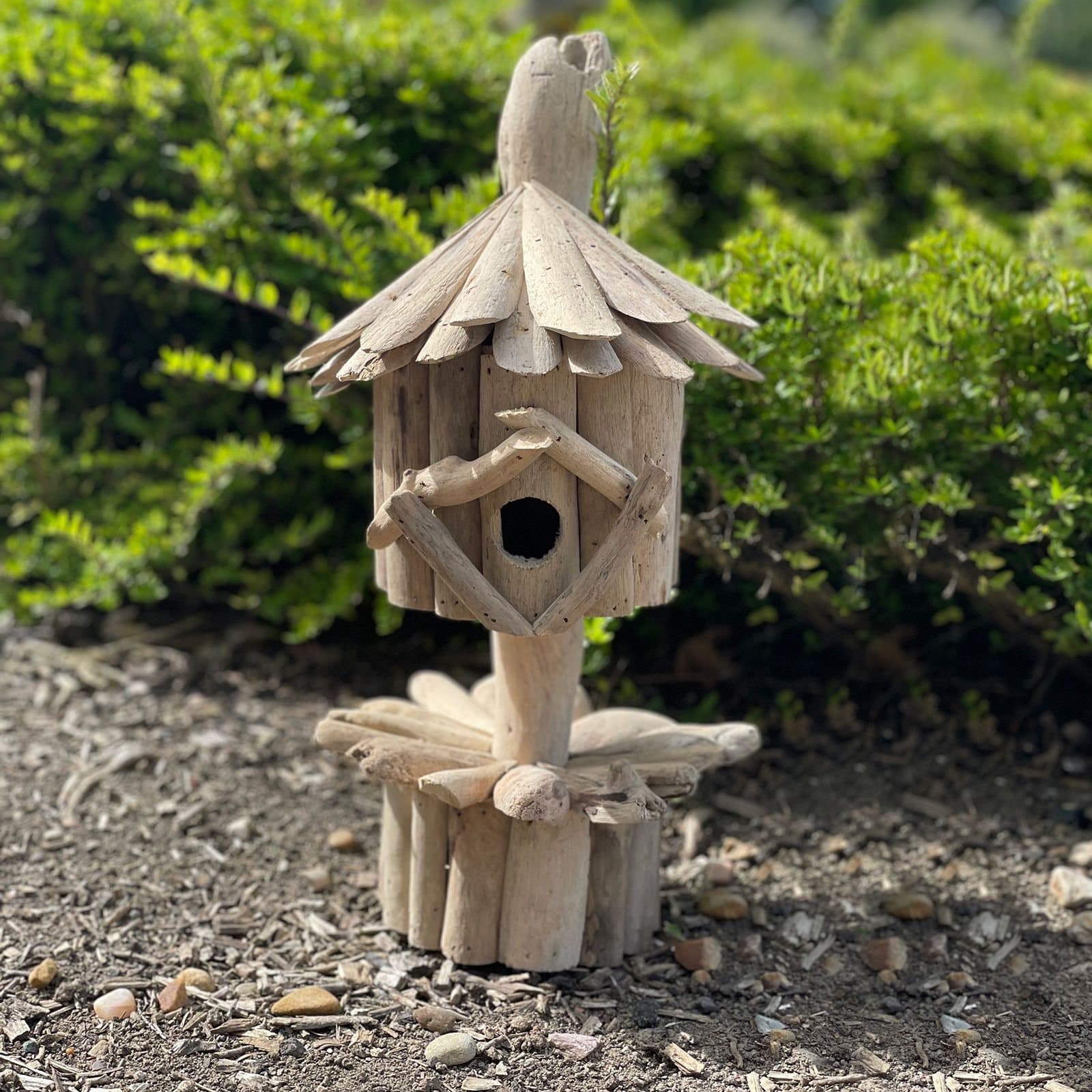 Handmade recycled driftwood bird box on a stand