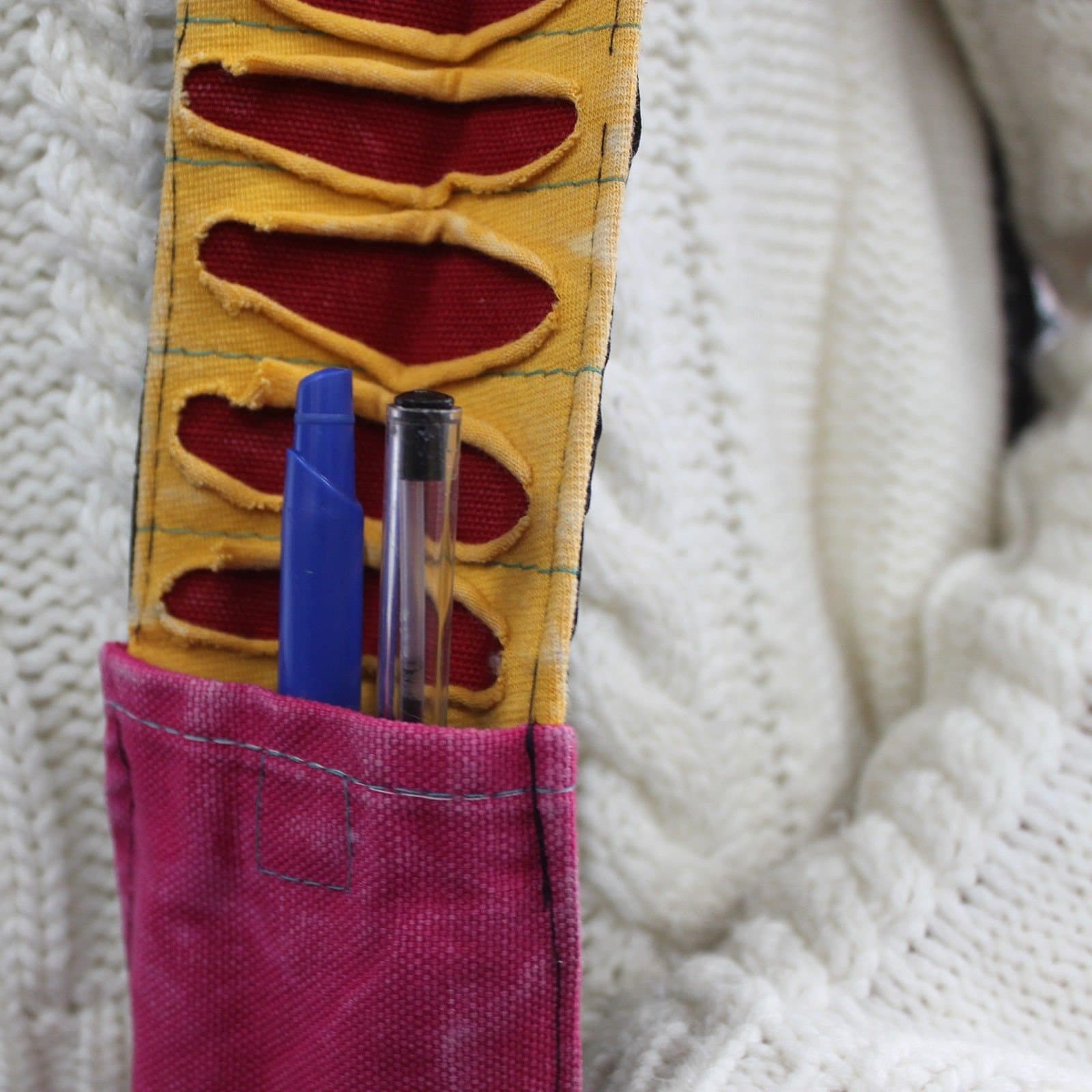 Purple cotton sling bag with a spiral design and a strap