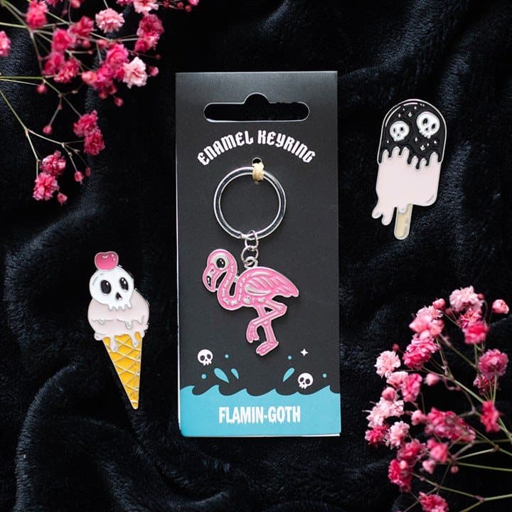 Enamel keyring with a bright pink skeletal flamingo design
