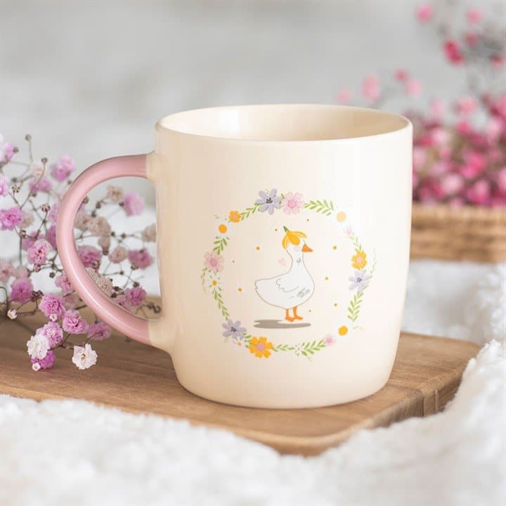 Ceramic mug with a duck inside a floral wreath