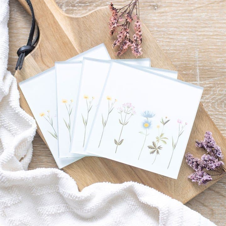 Set of glass coasters with a dainty floral design in a white box