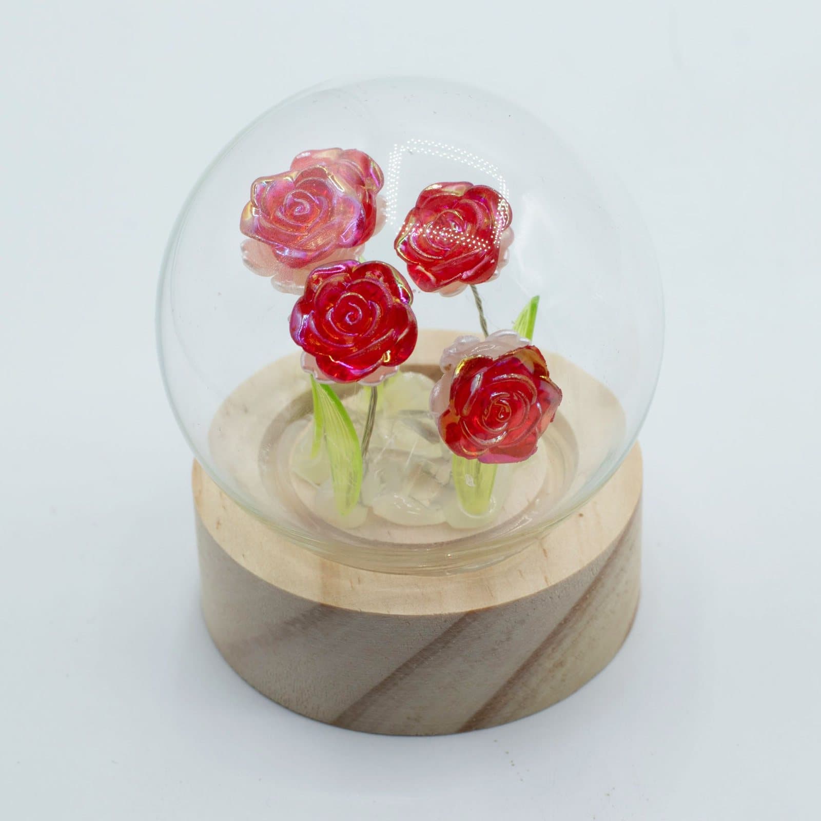 Floral Glow garden dome with roses under a glass dome on a wooden base