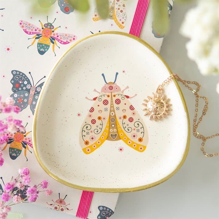 Speckled ceramic trinket dish with a floral moth design and gold edging