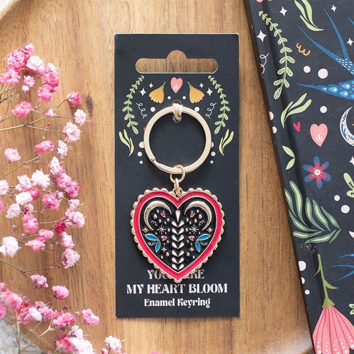 Colourful enamel folk heart keyring on a cardboard backing card