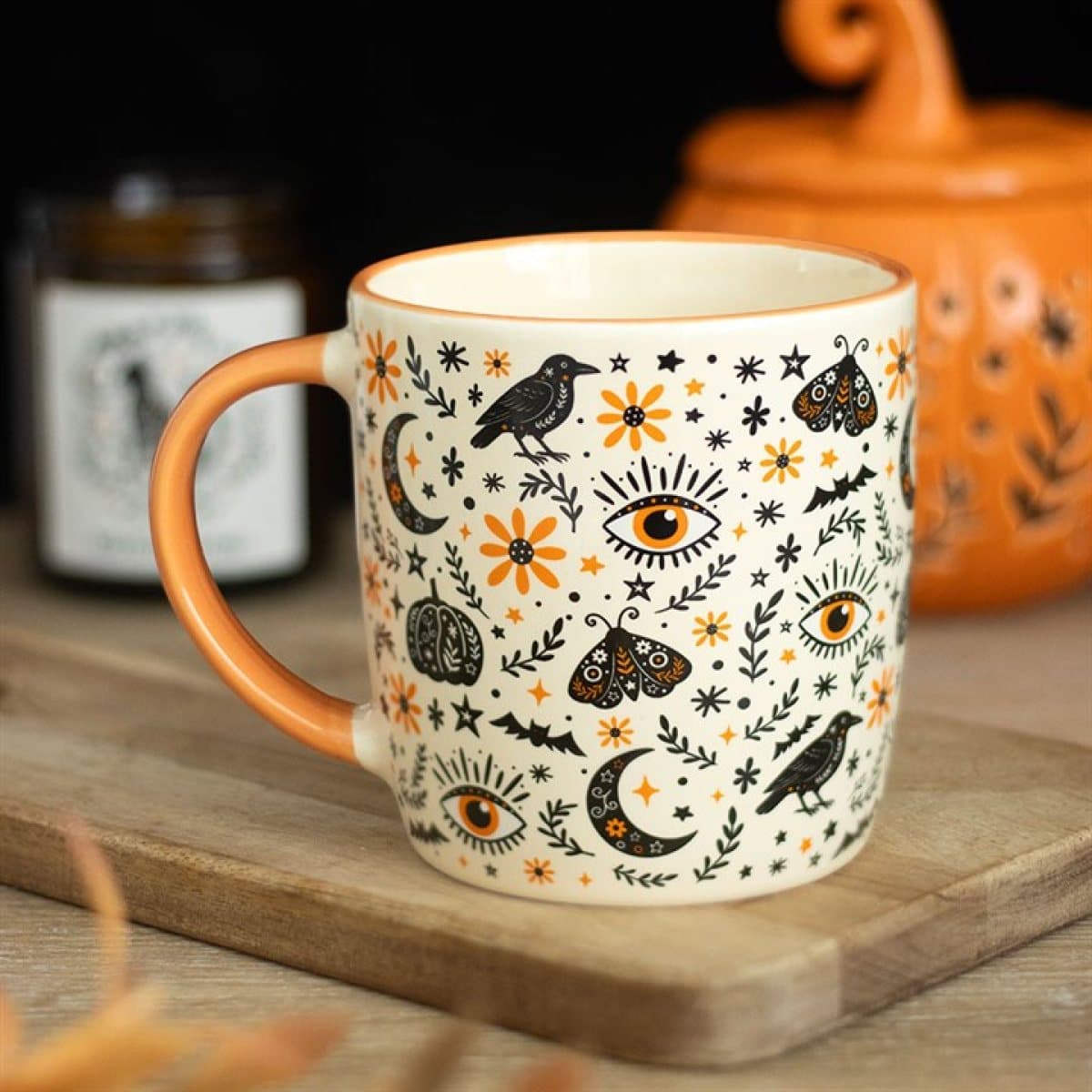 Ceramic mug with a folk print of ravens, moths, moons and flowers
