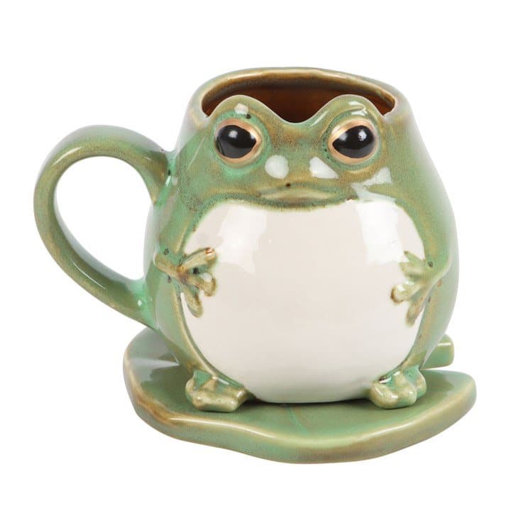 Ceramic frog shaped mug sitting on a matching green lily pad saucer