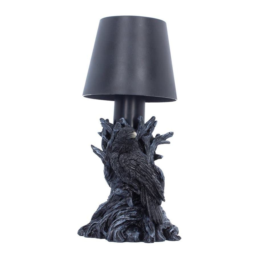 Black raven perched on a dark twisted branch lamp base