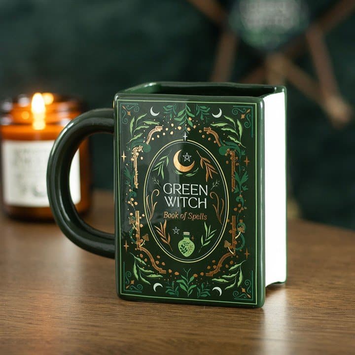 Ceramic mug shaped like a green spellbook with a Green Witch cover