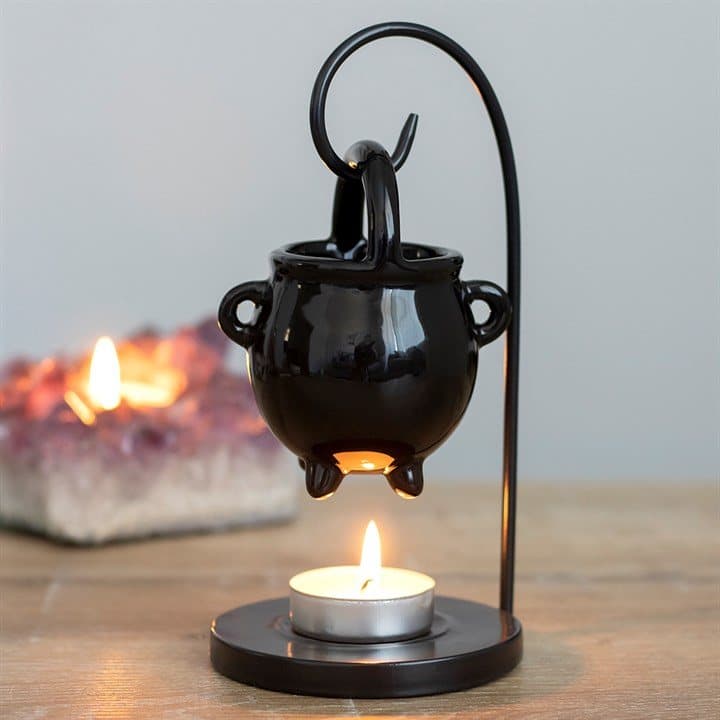 Small metal cauldron hanging from a frame