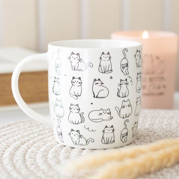 White ceramic mug with a pattern of sketched cats