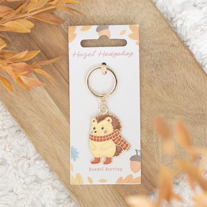 Hazel Hedgehog enamel keyring on a cardboard backing card