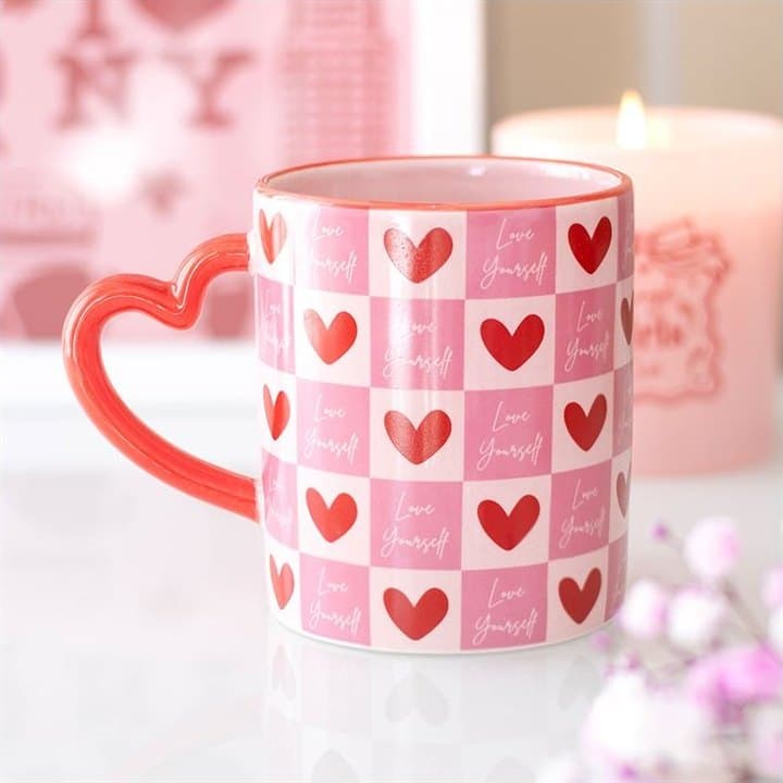 Checkered ceramic mug with a heart-shaped handle and a Love Yourself message