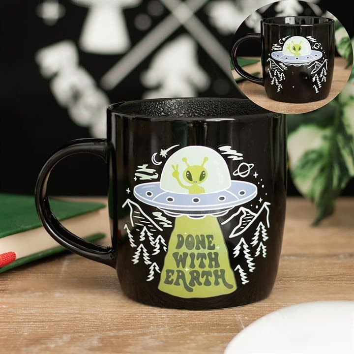 Ceramic UFO mug with a green alien and Done With Earth text